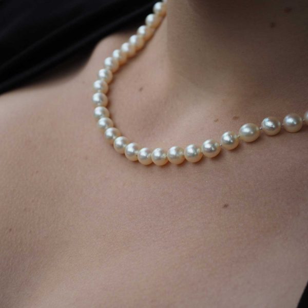 Pearl necklace around neck